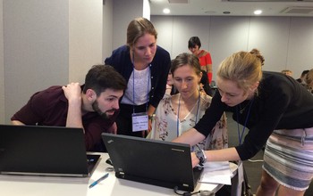 Awardee Cayelan Carey (far right) shows students how to run lake models on computers at a workshop.